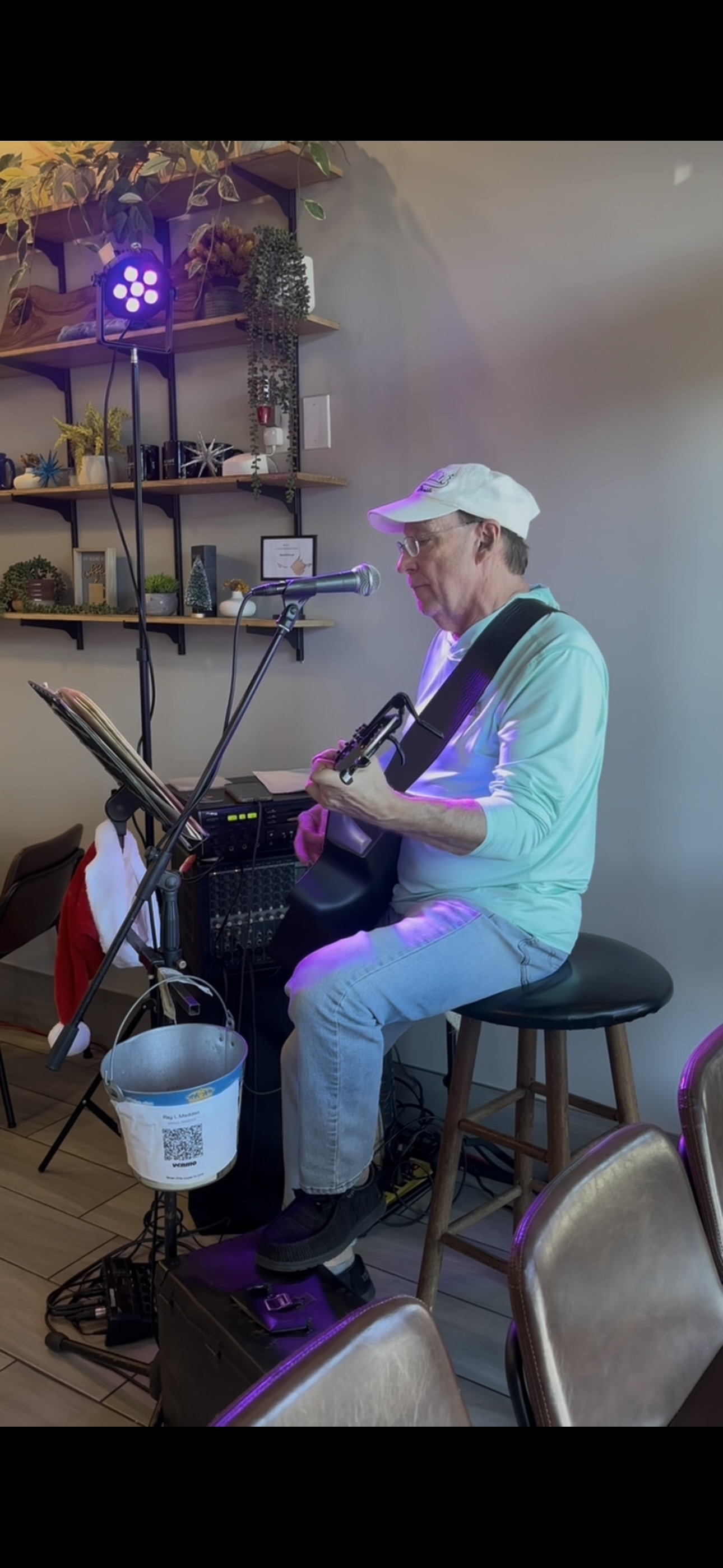 Lee Madden performing live with guitar